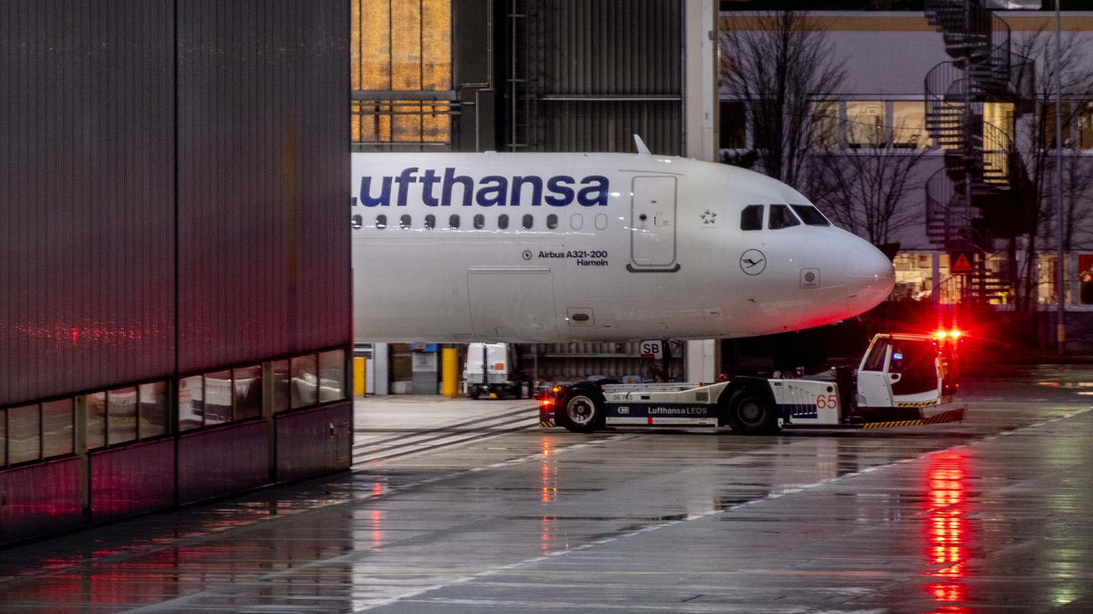 A Lufthansa aircraft is parked in a hangar at the airport in Frankfurt, Germany, Thursday, Feb. 1, 2024. Airport security staff started a one day warning strike at all important German airports causin ...