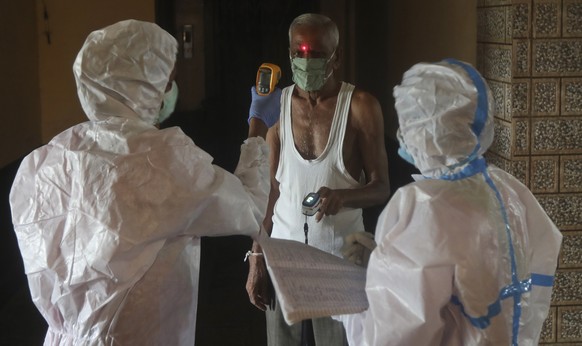 Health workers screen people for COVID-19 symptoms at a residential building in Dharavi , one of Asia&#039;s biggest slums, in Mumbai, India, Friday, Aug. 7, 2020. As India hit another grim milestone  ...