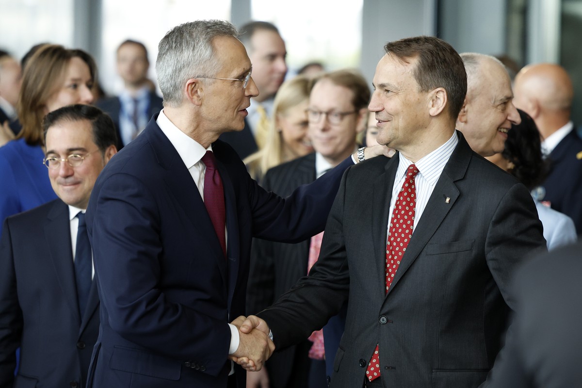 NATO Secretary General Jens Stoltenberg, left, shakes hands with Poland's Foreign Minister Radoslaw Sikorski a ceremony to mark the 75th anniversary of NATO at NATO headquarters in Brussels, Thur ...
