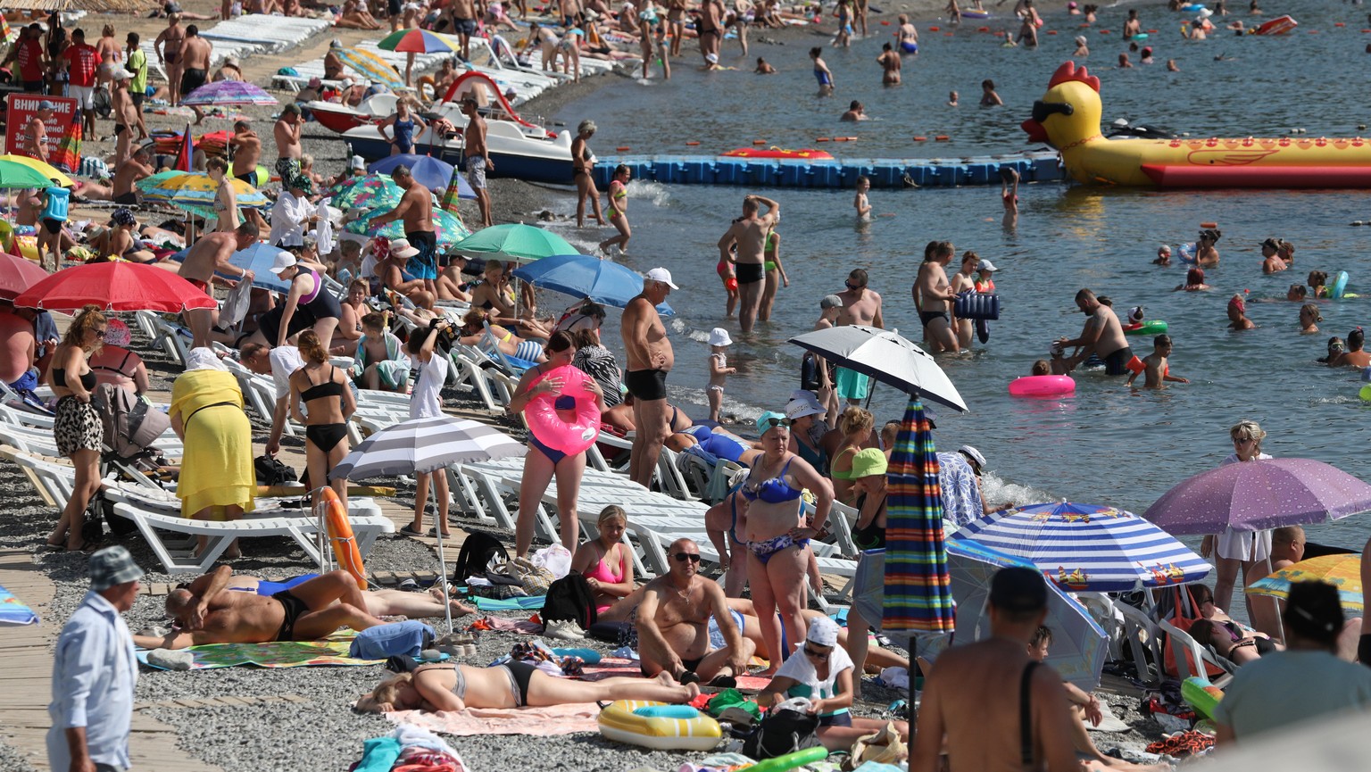 epa10778089 People enjoy a day at a beach of the Black Sea in Alushta, Crimea, 24 July 2023 (issued 31 July 2023). Crimea was annexed by Russia in 2014, shortly after Crimeans voted in a disputed refe ...