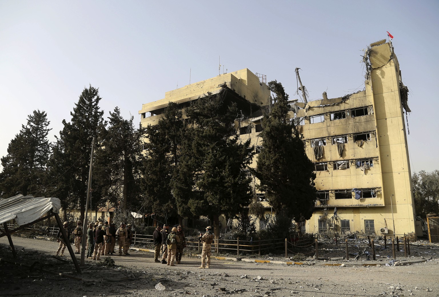 Iraqi security forces stand outside al-Salam hospital in Mosul, Iraq, Tuesday, Jan. 10, 2017. The Mosul hospital has been left almost completely gutted by the battle to retake it. Al-Salam hospital wa ...