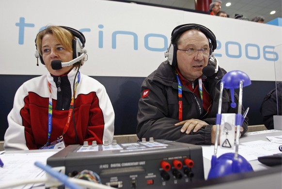 Swiss Bernard Thurnheer, commentator of Swiss Television, right, is assisted by Swiss Luzia Ebnoether, Curler and Silver medalist of the 2002 Salt Lake City Olympics Curling tournament as they cover t ...