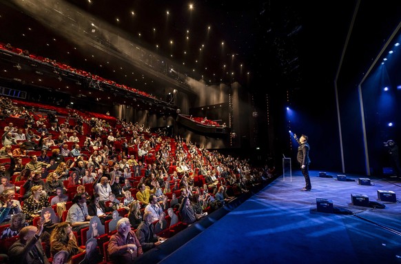 epa09026238 Visitors watch the performance of comedian Guido Weijers in Utrecht, The Netherlands, 20 February 2021. The event is part of a series of trial events in which Fieldlab is investigating how ...