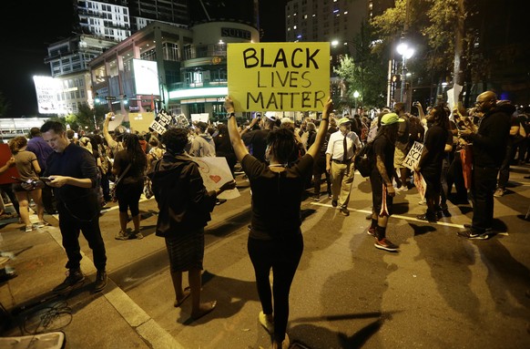 Protesters take to the streets of uptown during a peaceful march following Tuesday&#039;s police shooting of Keith Lamont Scott in Charlotte, N.C., Thursday, Sept. 22, 2016. (AP Photo/Gerry Broome)