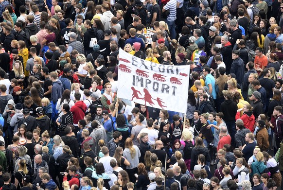 epa06994647 Concert goers stand with their banners in front of a stage in Chemnitz, Germany, 03 September 2018. German music groups give a free concert to support the civil society in Chemnitz. After  ...