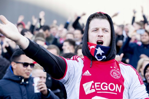 epa07556405 Supporters of Ajax cheer outside the &#039;Johan Cruijff ArenA&#039; prior to the UEFA Champions League, second leg soccer match between Ajax and Tottenham Hotspur in Amsterdam, The Nether ...