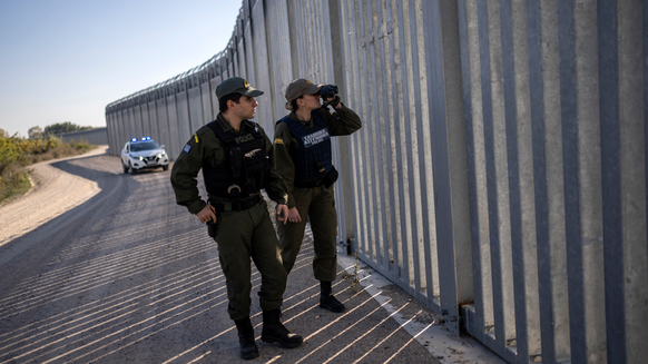FILE - Police border guards patrol along a border wall near the town of Feres, along the Evros River which forms the frontier between Greece and Turkey on Sunday, Oct. 30, 2022. Greece prevented some  ...