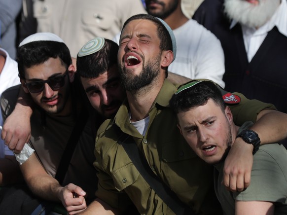 epa10493802 Relatives mourn during the funeral of two Israeli brothers Hillel and Yagel Yaniv at the Mount Herzl military cemetery in Jerusalem, 27 February 2023. Hillel and Yagel Yaniv were shot dead ...