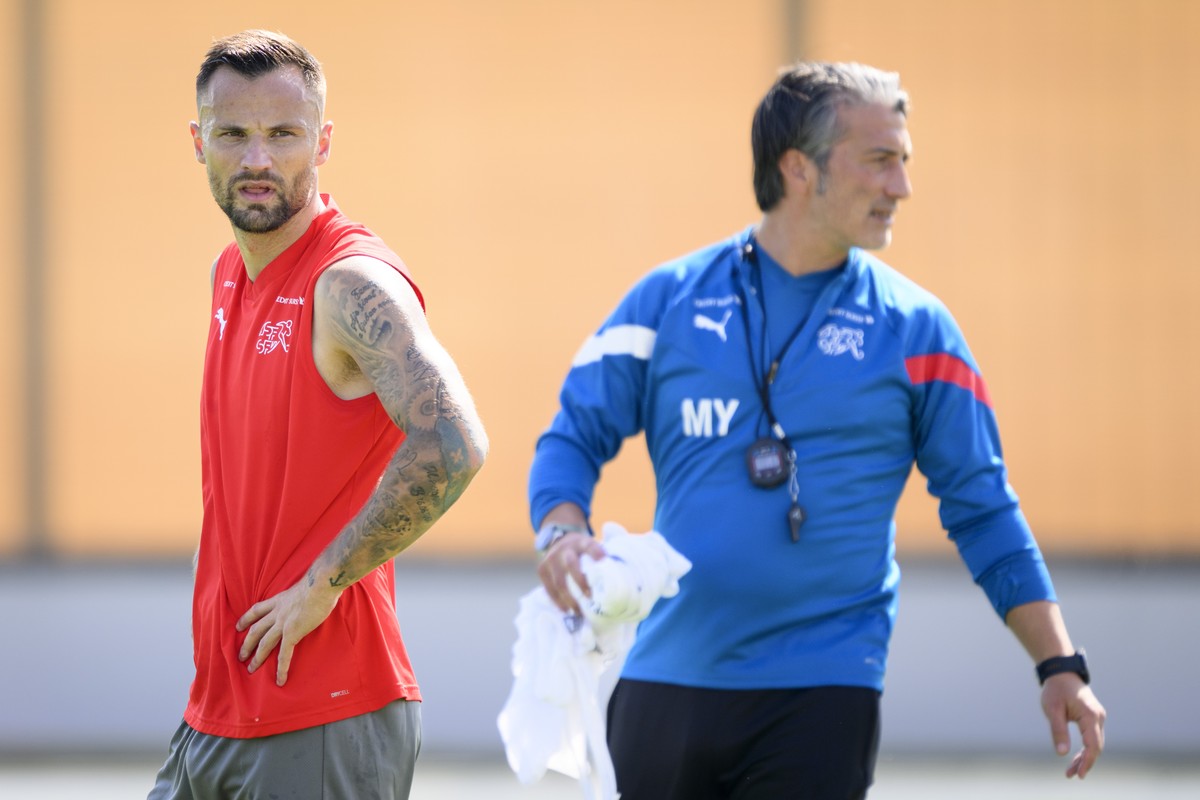 Switzerland's forward Haris Seferovic, left, and Switzerland's head coach Murat Yakin, right, attend a open training session of Swiss national soccer team in preparation for the FIFA World C ...