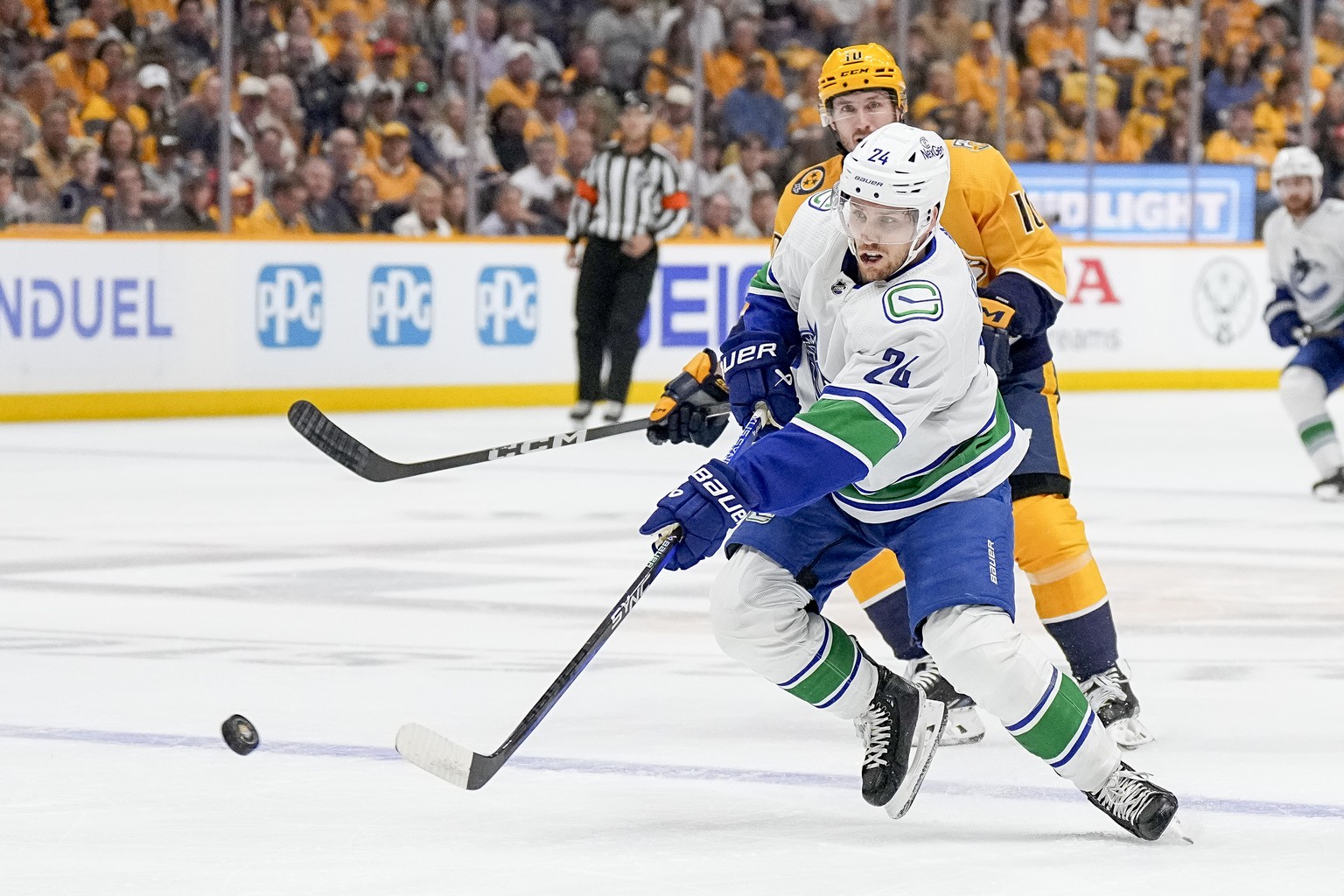 Vancouver Canucks center Pius Suter (24) passes the puck past Nashville Predators center Colton Sissons (10) during the first period in Game 6 of an NHL hockey Stanley Cup first-round playoff series F ...