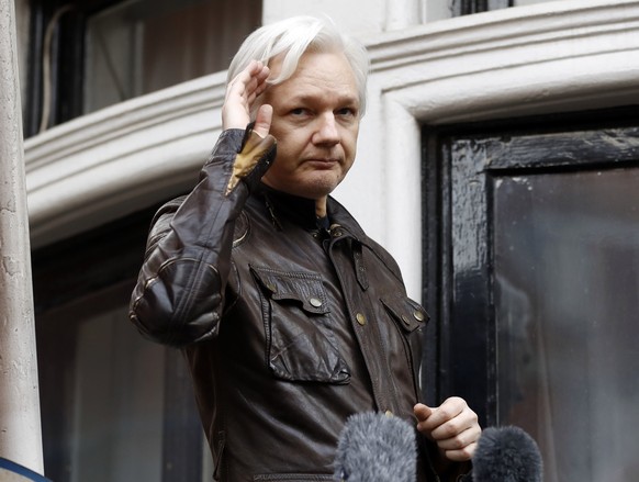 FILE - WikiLeaks founder Julian Assange greets supporters from a balcony of the Ecuadorian embassy in London, May 19, 2017. Britain