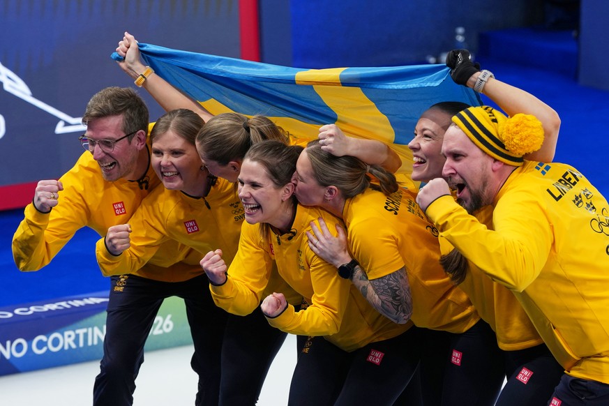Sweden's Anna Hasselborg, Sara McManus, Sofia Scharback and Agnes Knochenhauer celebrate defeating Switzerland to win a women's curling gold medal match, at the 2026 Winter Olympics, in Cort ...