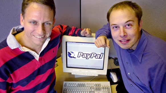 FILE--PayPal Chief Executive Officer Peter Thiel, left, and founder Elon Musk, right, pose with the PayPal logo at corporate headquarters in Palo Alto, Calif., on Oct. 20, 2000. Online auction giant e ...