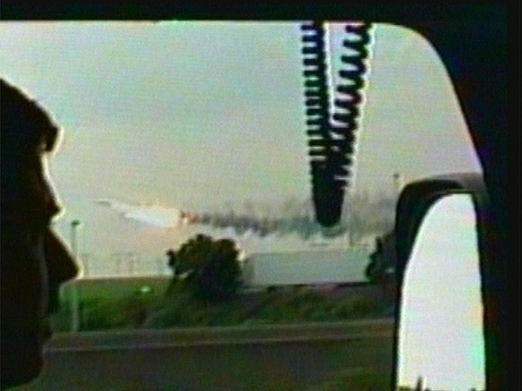 SIXTH OF AN EIGHT PICTURE SERIES - This image made from video, made available Wednesday, July 26, 2000, shows a man in a car viewing the Air France Concorde flight AF4590 on fire as it takes off from  ...