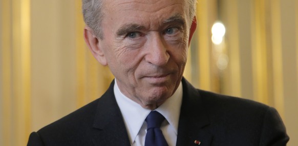 FILE - CEO of LVMH Bernard Arnault listens at the global tech conference Viva Technology at the Elysee Palace in Paris, Tuesday, Feb. 21, 2017. With a major sponsorship role aimed at burnishing the im ...