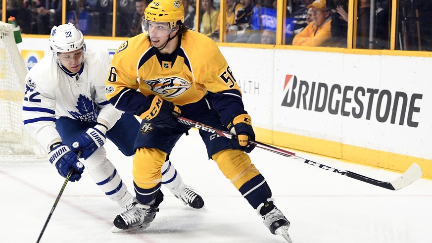 Mar 30, 2017; Nashville, TN, USA; Nashville Predators left wing Kevin Fiala (56) looks to pass the puck as he is defended by Toronto Maple Leafs defenseman Nikita Zaitsev (22) during the first period  ...