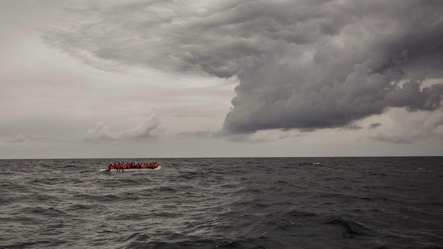 In this photo taken on Sunday Feb. 18, 2018 photo, refugees and migrants wait to be rescued by aid workers of the Spanish NGO Proactiva Open Arms, after leaving Libya trying to reach European soil abo ...