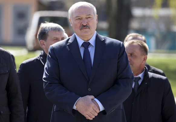 FILE - In this Monday April 26, 2021 file photo, Belarus President Alexander Lukashenko, accompanied by officials, attends a requiem rally on the occasion of the 35th anniversary of the Chernobyl disa ...