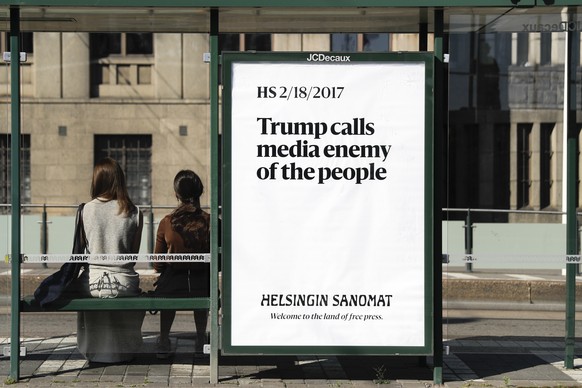 A poster reading &#039;Trump calls media enemy of the people&#039; is displayed by Finnish newspaper Helsingin Sanomat at a stop for public transport in Helsinki, Sunday, July 15, 2018. U.S. President ...