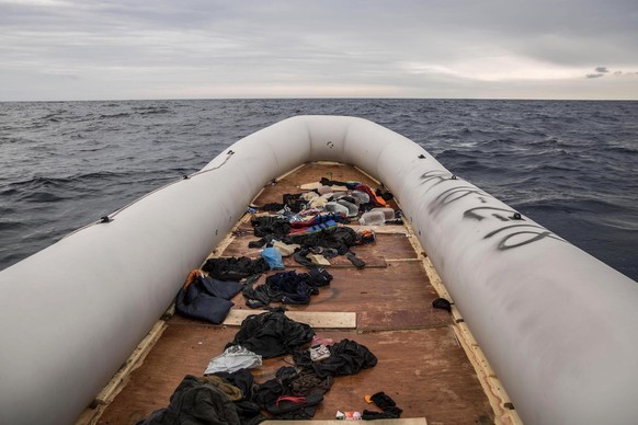 In this photo taken on Sunday Feb. 18, 2018 photo, migrants and refugees' personal belongings lie on a rubber boat after being rescued by aid workers of the Spanish NGO Proactiva Open Arms, after leav ...