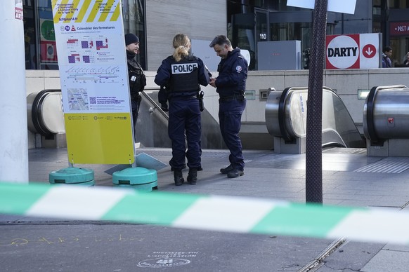 Police officers stand outside a subway station after a woman allegedly made threatening comments on a train, Tuesday, October 8.  31, 2023 in Paris.  Paris police opened fire on a woman who allegedly made threats…