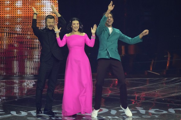 Hosts of the Eurovision Song Contest Laura Pausini, centre Alessandro Catalan, left and Mika onstage at the start of a rehearsal for the song contest in Turin, Italy, Monday, May 9, 2022. (AP Photo/Lu ...