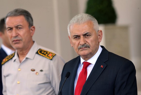 Turkey&#039;s Chief of Staff Gen. Hulusi Akar, left, stands next to Prime Minister Binali Yildirim at a press conference in Ankara, Turkey, Saturday, July 16, 2016. Forces loyal to Turkey&#039;s Presi ...