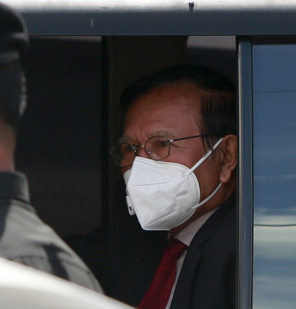 epa10040342 Kem Sokha (R), former leader of the opposition Cambodia National Rescue Party (CNRP), departs from the Municipal Court in Phnom Penh, Cambodia, June 29, 2022. The Municipal Court of Phnom Penh ...