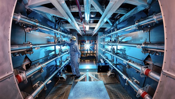 In this 2012 image provided by Lawrence Livermore National Laboratory, a technician reviews an optic inside the preamplifier support structure at the Lawrence Livermore National Laboratory in Livermor ...