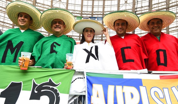 epa06815703 Supporters of Mexico pose before the FIFA World Cup 2018 group F preliminary round soccer match between Germany and Mexico in Moscow, Russia, 17 June 2018.

(RESTRICTIONS APPLY: Editorial Use Only, not used in association with any commercial entity - Images must not be used in any form of alert service or push service of any kind including via mobile alert services, downloads to mobile devices or MMS messaging - Images must appear as still images and must not emulate match action video footage - No alteration is made to, and no text or image is superimposed over, any published image which: (a) intentionally obscures or removes a sponsor identification image; or (b) adds or overlays the commercial identification of any third party which is not officially associated with the FIFA World Cup) ONLY  EPA/FACUNDO ARRIZABALAGA   EDITORIAL USE ONLY