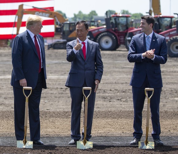 epa06848696 US President Donald J. Trump, left, Terry Gou, Chairman of Foxconn, and House speaker Paul Ryan during the official groundbreaking for the Foxconn factory in Mount Pleasant, Wisconsin, USA ...