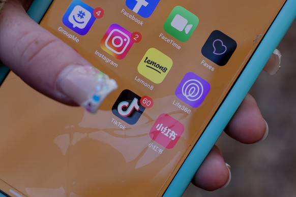 epa11832179 An iPhone user with the TikTok app and other social media apps in Decatur, Georgia, USA, 17 January 2025. The US Supreme Court has backed a law banning the Chinese-owned TikTok app in the  ...