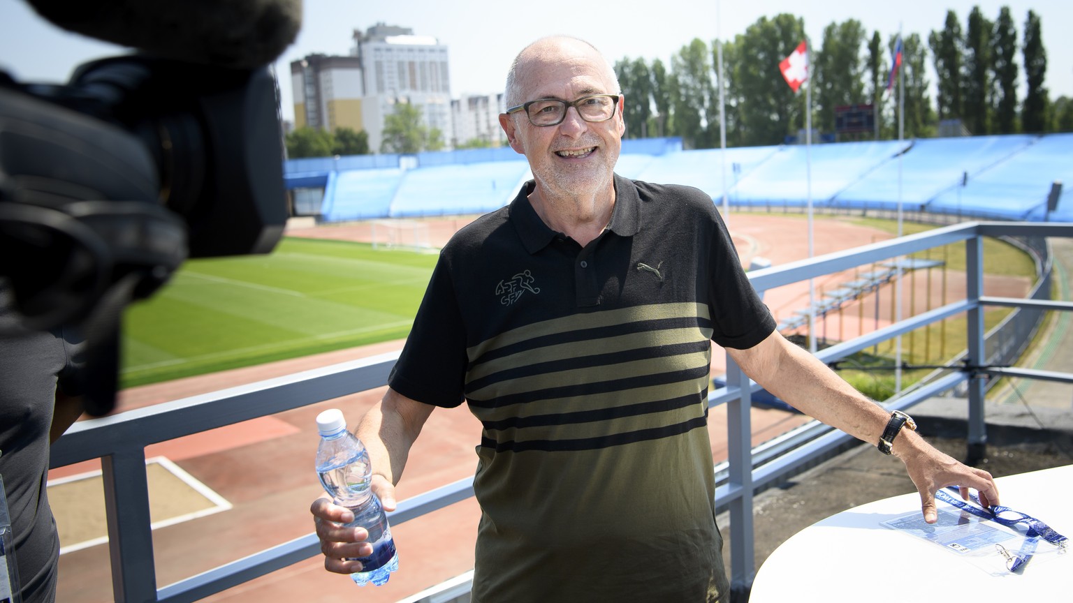 Peter Gillieron, President of the Swiss Football Association, SFV, answers questions from TV journalist before a press conference of the Switzerland&#039;s national soccer team at the Torpedo Stadium, ...