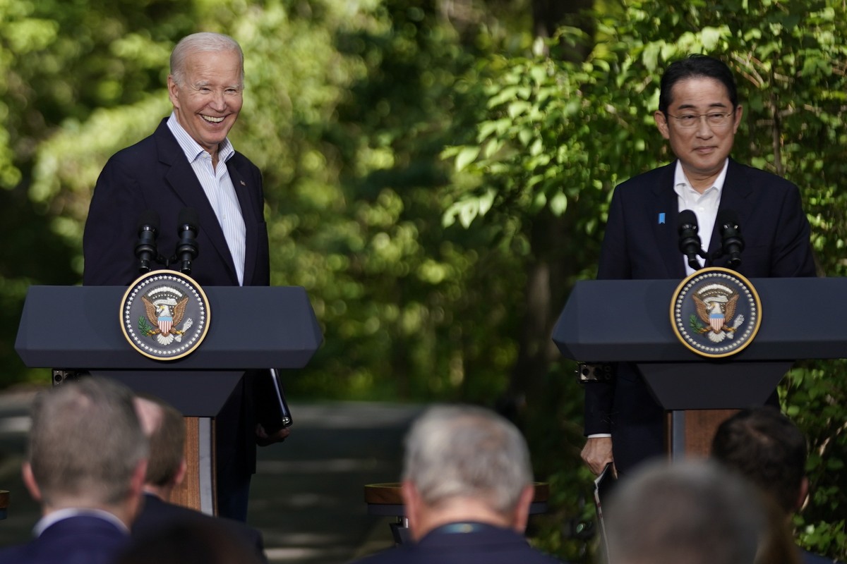 President Joe Biden smiles during a news conference with Japan's Prime Minister Fumio Kishida, right, and South Korea's President Yoon Suk Yeol, not pictured, Friday, Aug. 18, 2023, at Camp  ...