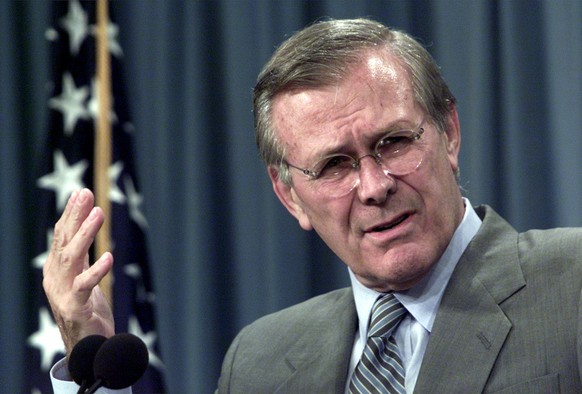Secretary of Defense Donald Rumsfeld talks with reporters about Iraq at the Pentagon in Washington Friday, August 3, 2001. (AP Photo/Hillery Smith Garrison)
