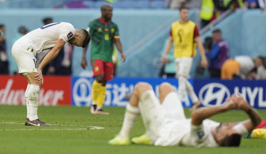 Players of Serbia react after their team&#039;s 3-3 tie during the World Cup group G soccer match between Cameroon and Serbia, at the Al Janoub Stadium in Al Wakrah, Qatar, Monday, Nov. 28, 2022. (AP  ...