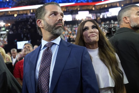Donald Trump Jr., and his fianc� Kimberly Guilfoyle, watch the roll call of states during the first day of the Republican National Convention, Monday, July 15, 2024, in Milwaukee. (AP Photo/Evan Vucci ...