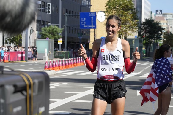 epa09402221 Fabienne Schlumpf of Switzerland reacts after finishing twelfth in the the Women&#039;s Marathon during the Athletics events of the Tokyo 2020 Olympic Games at the Odori Park in Sapporo, J ...