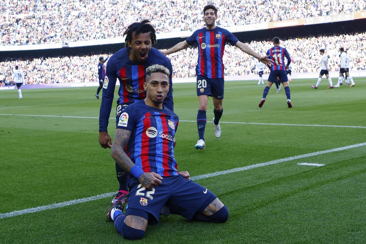 Barcelona's Raphinha celebrates scoring his side's opening goal during Spanish La Liga soccer match between Barcelona and Valencia at the Camp Nou stadium in Barcelona, Spain, Sunday, March  ...