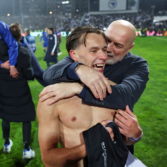 Bosnia's Amar Dedic and Bosnia's coach Sergej Barbarez, right, celebrate after winning a penalty shootout during the World Cup qualifying playoff final soccer match between Bosnia and Italy  ...