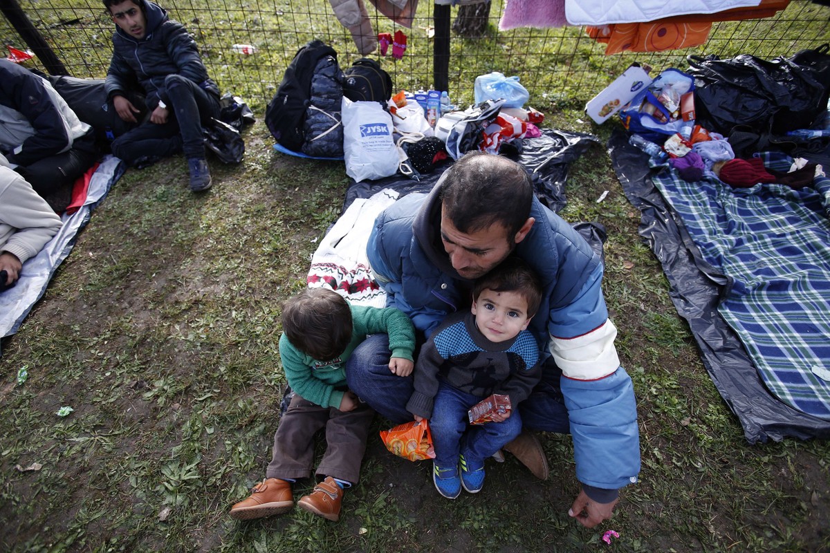 Migrants are camped near a police barricade at a border crossing in Izacici near Bihac, on Bosnia's border with Croatia, Tuesday, Oct. 23, 2018. Several dozen migrants, including children, have s ...