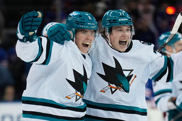 San Jose Sharks&#039; Will Smith, left, celebrates his winning goal with Macklin Celebrini at the end of the overtime period of an NHL hockey game in New York, Thursday, Oct. 23, 2025. (AP Photo/Seth  ...