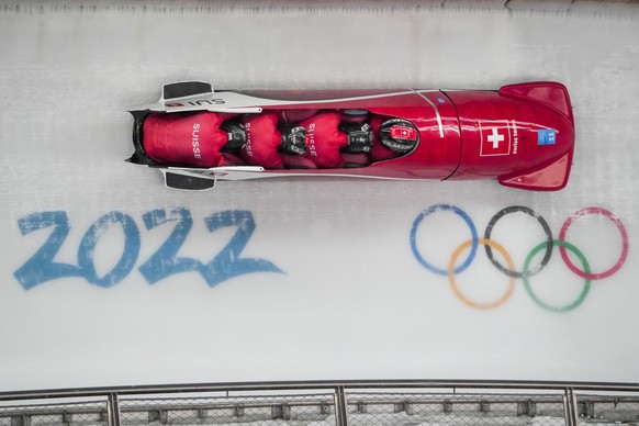 Michael Vogt, Luca Rolli, Cyril Bieri and Sandro Michel, of Switzerland, slide during the 4-man heat 1 at the 2022 Winter Olympics, Saturday, Feb. 19, 2022, in the Yanqing district of Beijing. (AP Pho ...