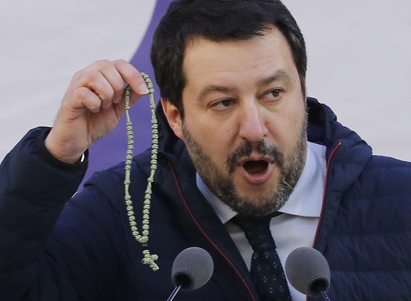 FILE - In this photo taken on Feb. 24, 2018, leader of The League party Matteo Salvini shows a rosary as he addresses a rally in Milan, Italy. For months now, Salvini _ a divorced father of two childr ...