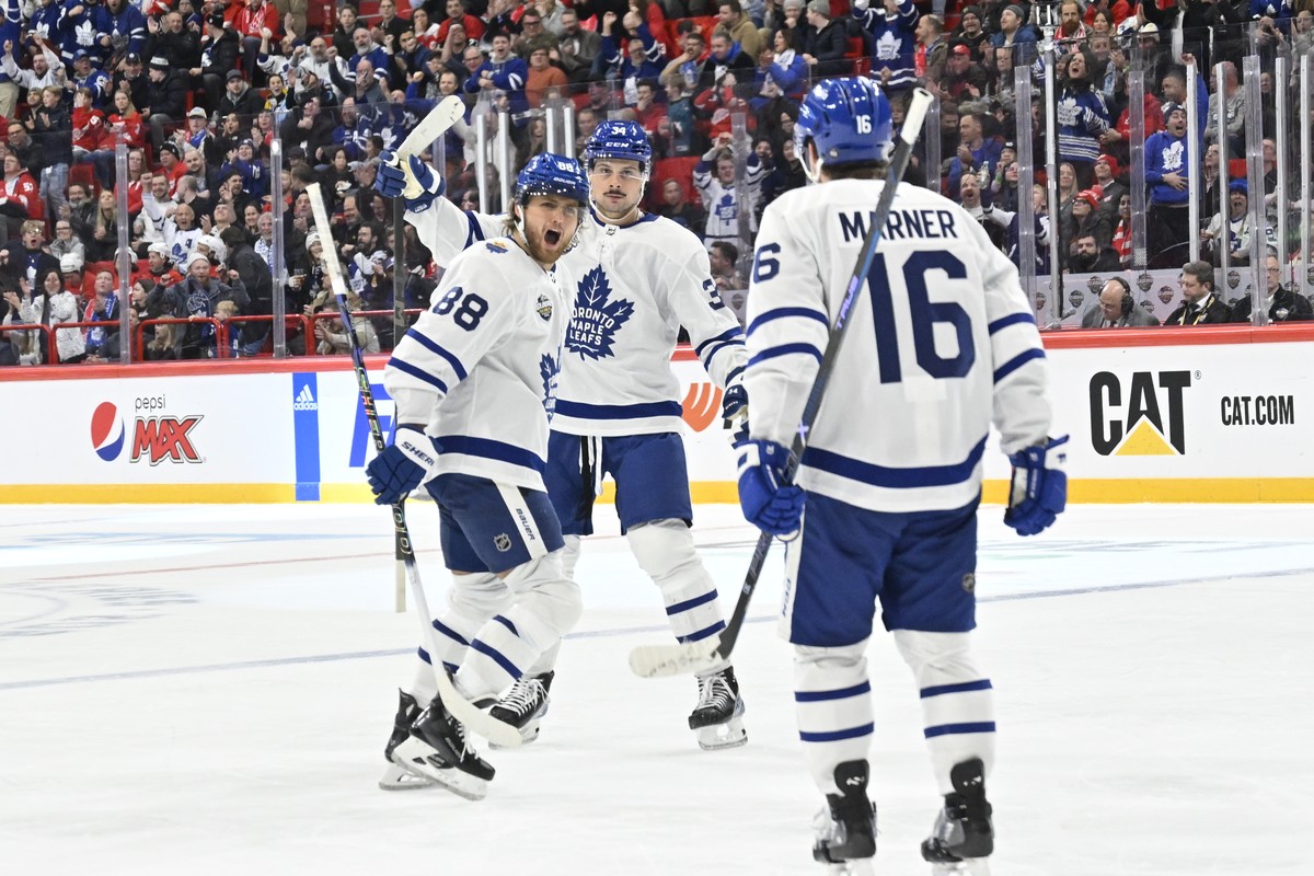 epa10981615 Toronto's William Nylander (L) celebrates scoring with Auston Matthews (C) and Mitchell Marner (R) during the NHL Global Series Sweden ice hockey game between the Toronto Maple Leafs  ...