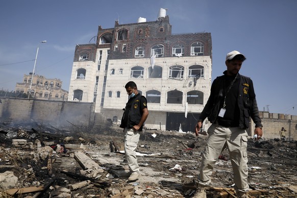 epa09850593 Yemenis inspect a site of Saudi-led airstrikes targeting two houses, killing at least eight people, a day after the Houthis unleashed a wave of drone and missile attacks on Saudi Arabia, i ...