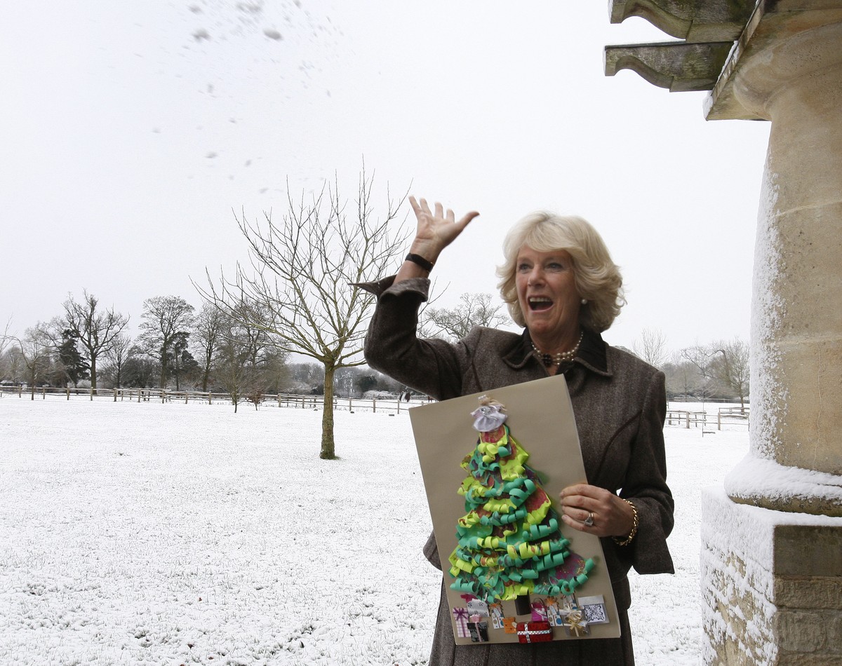 FILE - Britain's Camilla, Duchess of Cornwall throws a snowball after attending a tea party for children from Ty Hafan hospice in Wales, at Highgrove House in Gloucestershire, England, Monday, De ...