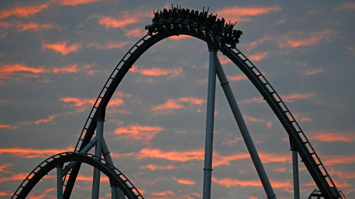 epaselect epa04385303 Visitors take a ride on the rollercoaster 'Silver Star' as the sun sets in the background at the Europa Park, in Rust, Germany, 04 September 2014. EPA/PATRICK SEEGER