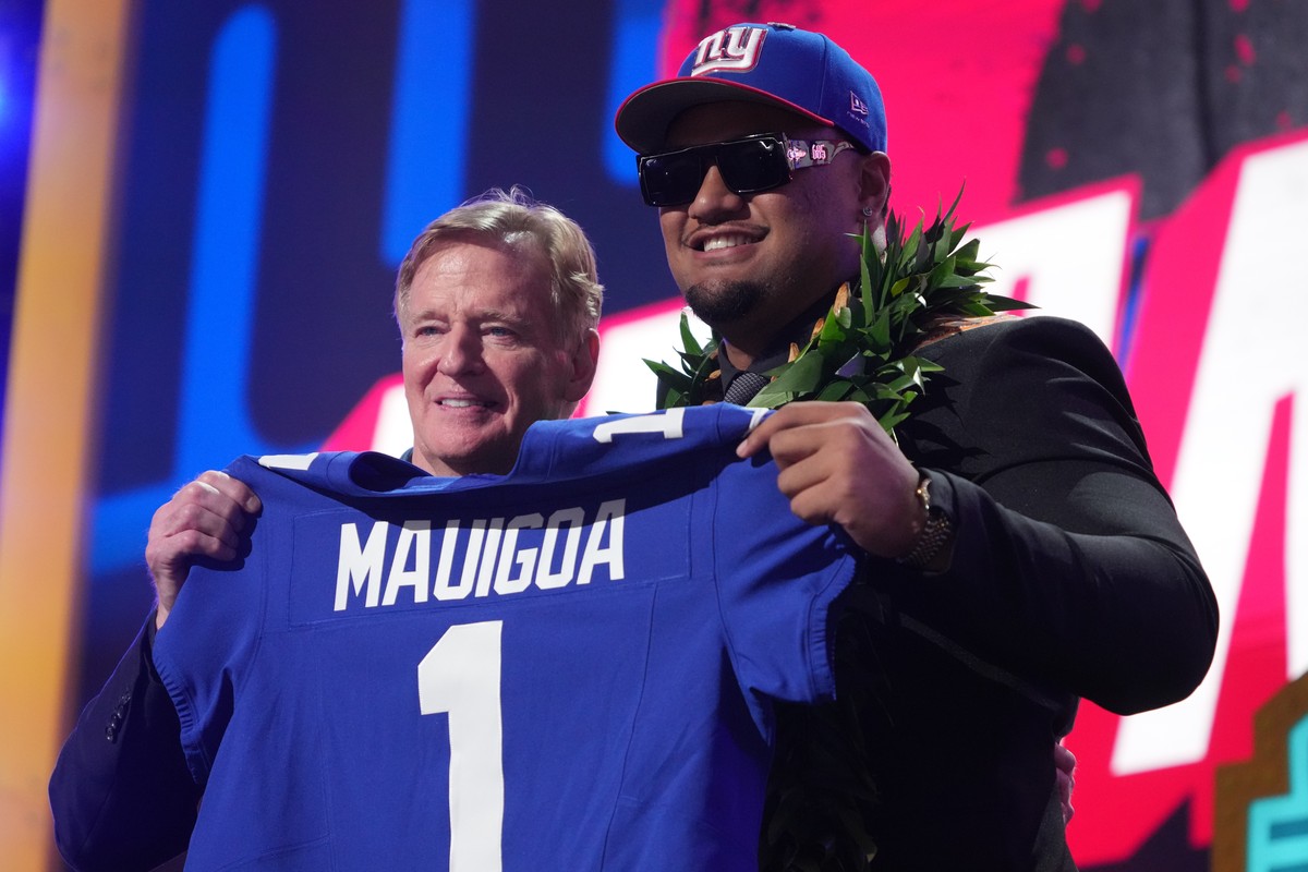 Miami offensive lineman Francis Mauigoa, right, poses with NFL Commissioner Roger Goodell after being chosen by the New York Giants with the 10th overall pick during the first round of the NFL footbal ...