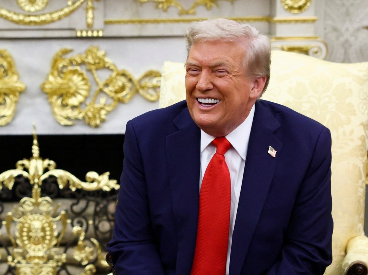 U.S. President Donald Trump laughs while Ukrainian President Volodymyr Zelenskiy gestures as they meet at the Oval Office of the White House, amid negotiations to end the Russian war in Ukraine, in Wa ...